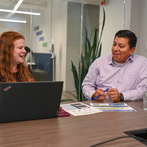 Two people in office having lively discussion