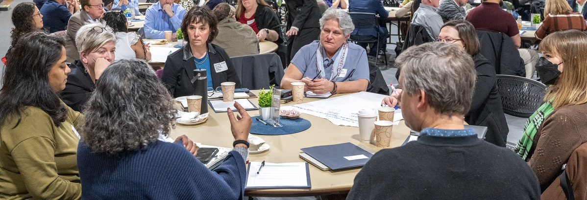 People in discussion around a table