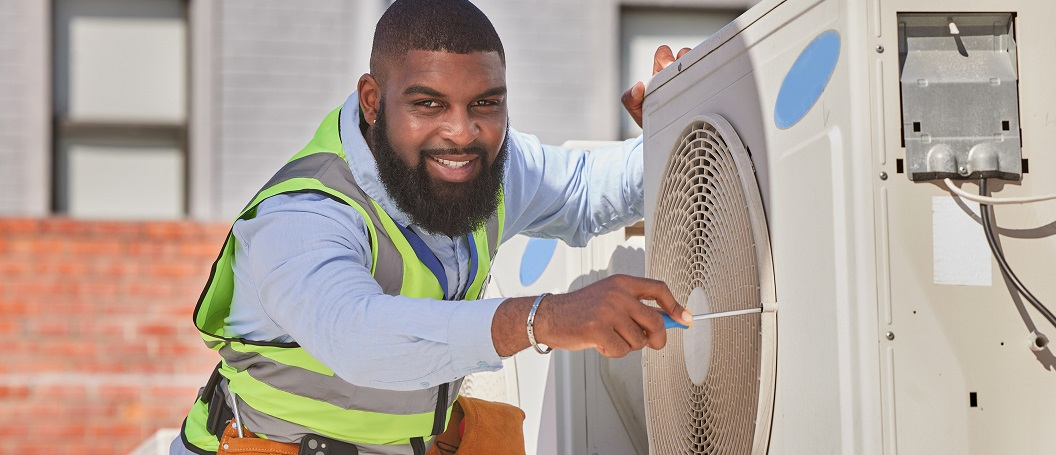 HVAC technician working on rooftop system