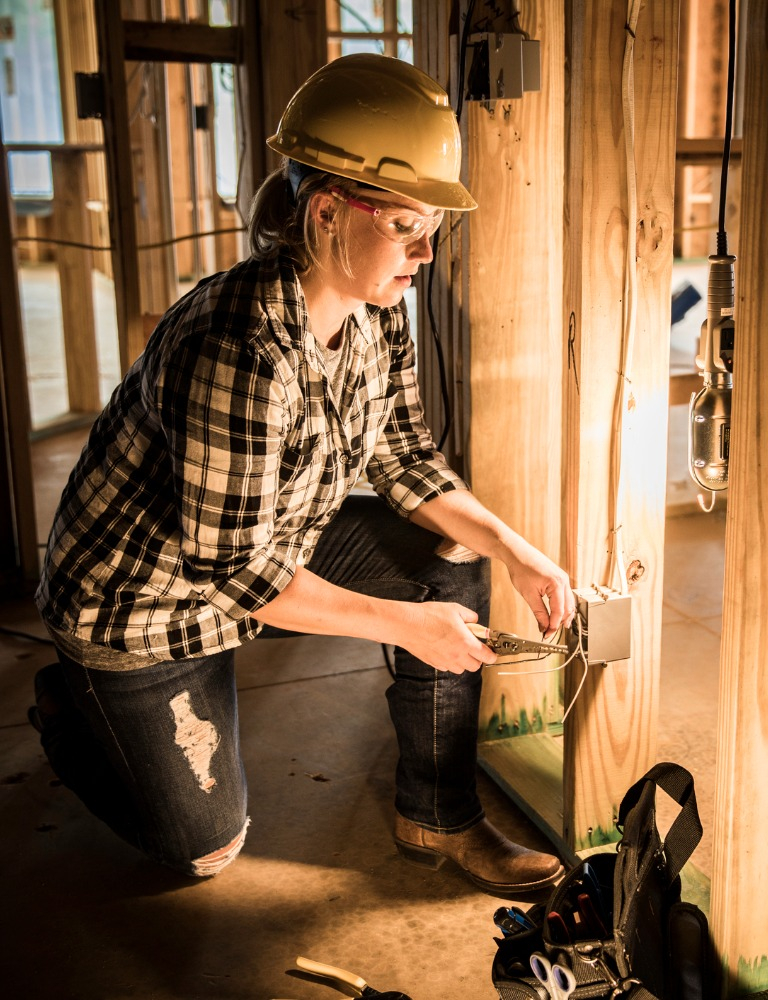 Female electrician at home construction site