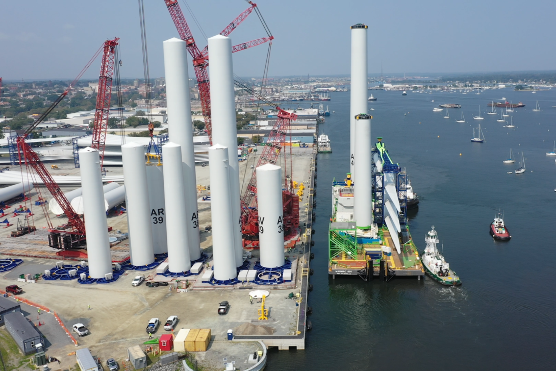 Aerial view of New Bedford terminal with wind turbine components and construction ship
